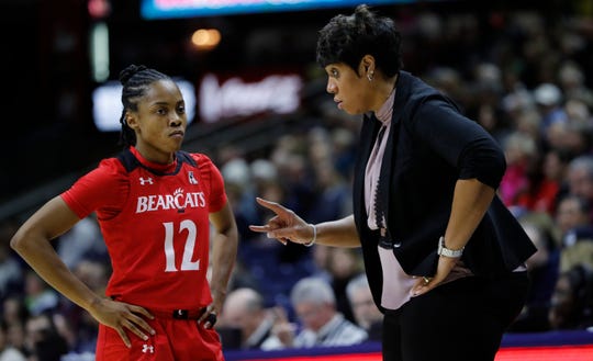 Cincinnati Bearcats head coach Michelle Clark-Heard talks with guard Antoinette Miller (12) from the sideline in the first quarter against the Connecticut Huskies at Gampel Pavilion.