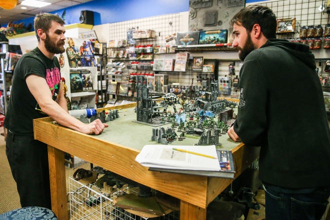 Sean Day, left, and Chris Morise play Warhammer 40,000, a tabletop strategy game Thursday, Jan. 10, 2019, at Specialties Games Toys & Gifts.