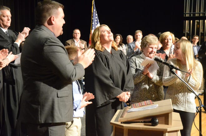 Judge Tomak looks upward after taking the oath of office during the ceremony Friday.