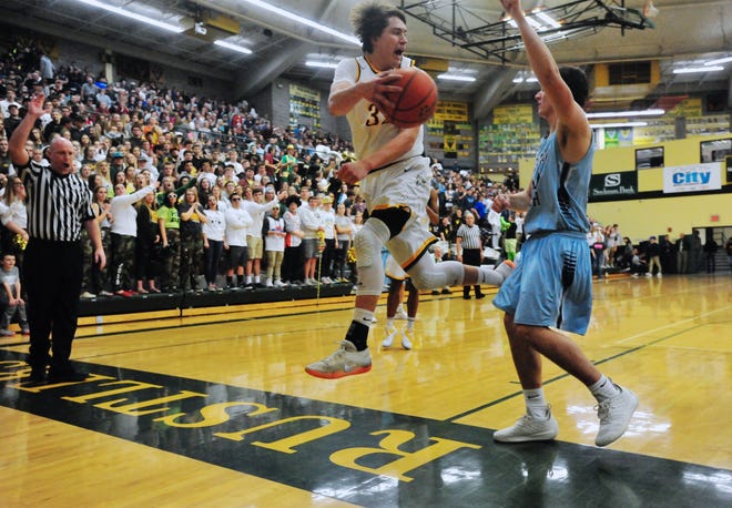 CMR's Bryce Depping attempts to save the ball from going out of bounds during the crosstown basketball game, Thursday night, in the CMR Fieldhouse.