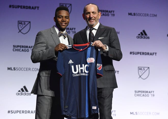 DeJuan Jones greets MLS commissioner Don Garber after being selected as the number eleven overall pick to the New England Revolution in the first round of the 2019 MLS Super Draft at McCormick Place.