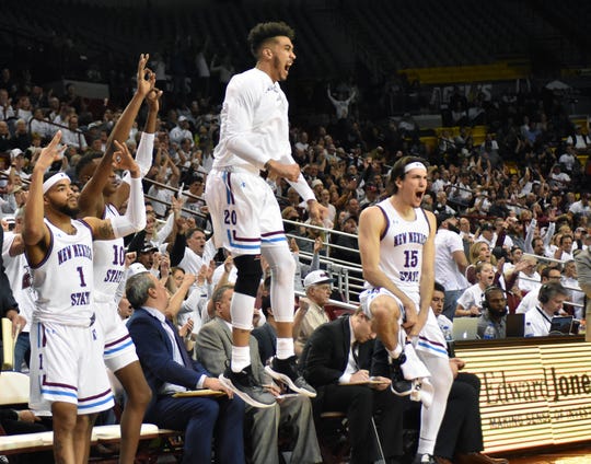 The NMSU Aggie bench celebrates after a teammate sinks a 3-point shot against Grand Canyon University on Thursday, Jan. 10, 2019, at the Pan Am Center.  The Aggies would win 77-75 on a Johnny McCants half-court shot at the buzzer.