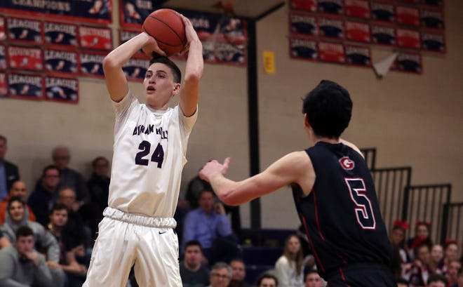 Byram Hills Mike Parrotta (24) puts up a shot in front of Rye's Troy Egan (5) during boys basketball action at Byram Hills High School in Armonk Jan. 10, 2019. Byram Hills won the game.