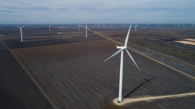 Wind turbines spin in San Patricio County near Portland, Texas on Dec. 12, 2018. There are nearly 13,000 wind turbines operating in Texas for electricity.