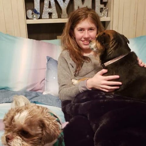 Jayme Closs smiles with the family pets at her...