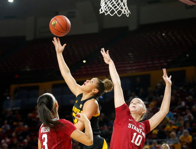 Arizona State University Taya Hanson (0)  takes a shot while being guarded by Stanford University Anna Wilson (3) and Alyssa Jerome (10) during a women's basketball game at Well Fargo Arena in Tempe on January 11.