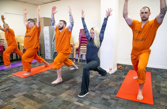 Volunteer Allison Merlo helps run a yoga class offered by the Prison Yoga Project Phoenix at the Maricopa County Towers Jail complex on Jan. 11, 2019.