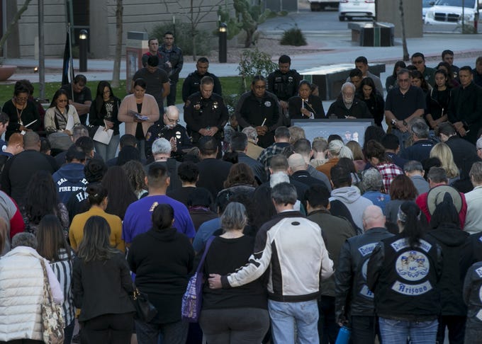 Salt River Police Chief Karl Auerbach (center left, in front of the microphone) leads a vigil in prayer in remembrance of Salt River tribal police Officer Clayton Townsend at Two Waters Courtyard in Scottsdale on Jan. 11, 2019. Townsend was killed while conducting a traffic stop along Loop 101 near Scottsdale.