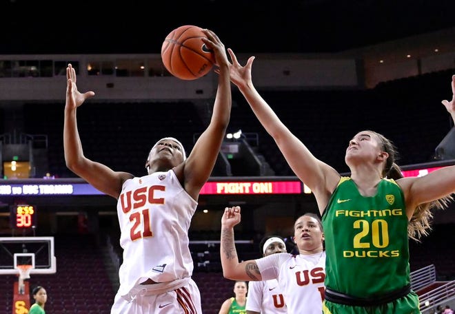 Southern California's Aliyah Mazyck, left, and Oregon's Sabrina Ionescu reach for a rebound during the second half of an NCAA college basketball game Friday, Jan. 11, 2019, in Los Angeles. Oregon won 93-53. (AP Photo/Mark J. Terrill)