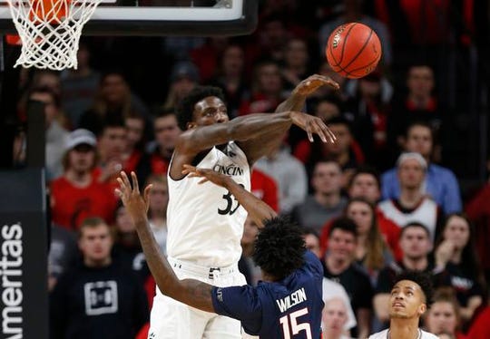Cincinnati Bearcats center Nysier Brooks (33) blocks a shot by Connecticut Huskies guard Sidney Wilson (15) during the first half of a basketball game Saturday, Jan. 12, 2019 in Cincinnati. (Photo by Gary Landers for the Enquirer)