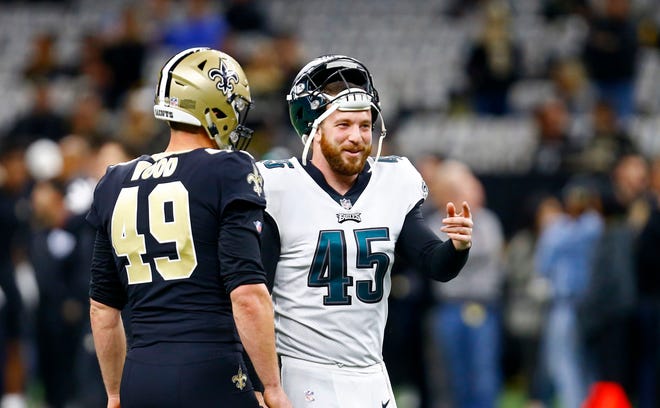Philadelphia Eagles long snapper Rick Lovato (45) and New Orleans Saints long snapper Zach Wood (49) talk before an NFL divisional playoff football game in New Orleans, Sunday, Jan. 13, 2019. (AP Photo/Butch Dill)