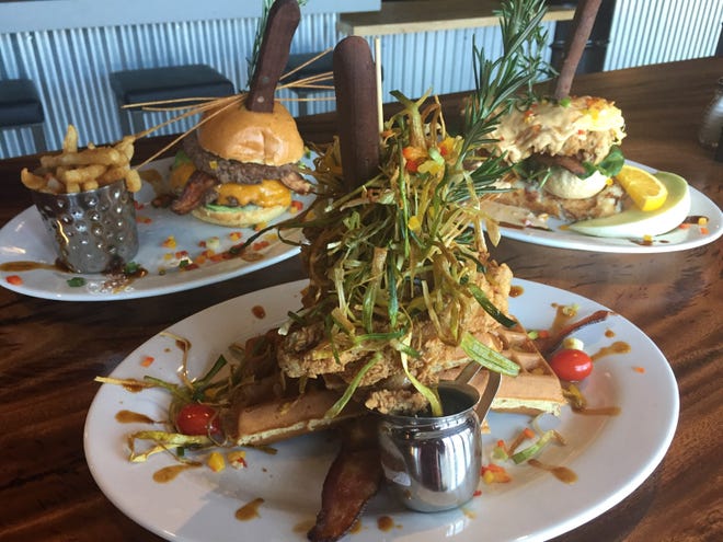 At Hash House a Go Go, Andy's Famous Sage Fried Chicken, served with waffles is the star of the show. At left is one of the restaurant's many stuffed burgers, and at right, a Sage Fried Chicken Benedict.
