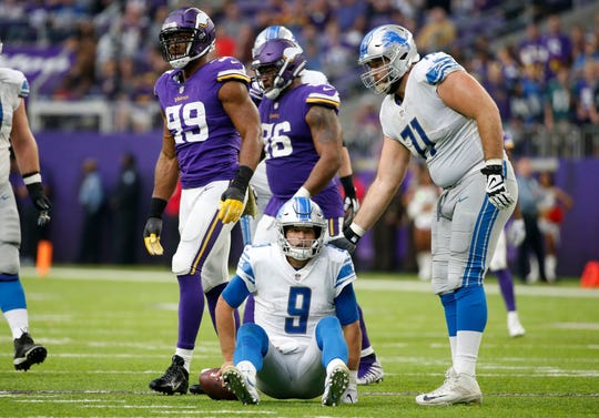 Lions quarterback Matthew Stafford sits on the field next to offensive lineman Rick Wagner after getting sacked by Vikings defensive end Danielle Hunter (99) during the first half of the Lions' 24-9 loss Sunday, Nov. 4, 2018, in Minneapolis.