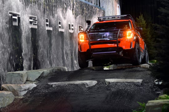 Media members are given rides in a Kia Telluride, with this model being custom built for this indoor course, Monday at Cobo Center.