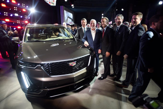From the left, Tennessee Governor Bill Leelam, Tennessee Governor, Cadillac President Steve Carlisle, current Tennessee Governor Bill Haslam, Tennessee Department of Economic and Community Development Commissioner Bob Rolfe, and Andrew Smith, executive director of Cadillac Design, gather around the newly released 2020 Cadillac XT6 Sunday, January 13, 2019 at the Garden Theater in Detroit.