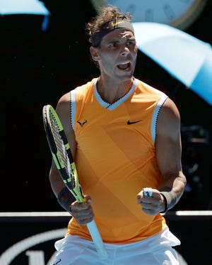 Spain's Rafael Nadal celebrates after defeating Australia's James Duckworth in their first round match at the Australian Open tennis championships in Melbourne.