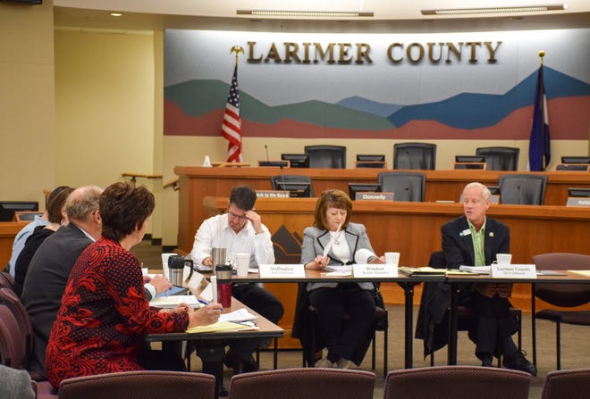 Larimer County Commissioner Steve Johnson, right, addresses fellow members of the Larimer County Behavioral Health Policy Council during its inaugural meeting on Jan. 14, 2019.
