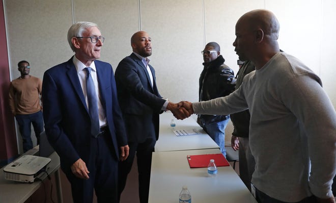 Lt. Gov. Mandela Barnes shakes hands with WRTP/Big Step participant Thadius Jones with Gov. Tony Evers (far left), during a tour at the WRTP/Big Step at 3841 W. Wisconsin Ave. in Milwaukee on Monday.