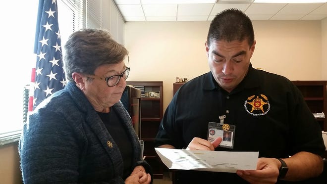 Newly seated Doña Ana County Sheriff Kim Stewart, left, looks over a document with Undersheriff Jaime Quezada on Friday, Jan. 4, 2019 at the Doña Ana County Government Center, 845 N. Motel Blvd., in Las Cruces.