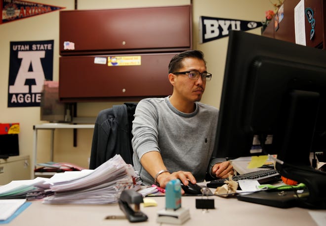 Renaldo Harvey, office specialist for the Office of Navajo Nation Scholarship and Financial Assistance, updates an applicant's file on Monday in Window Rock, Ariz.