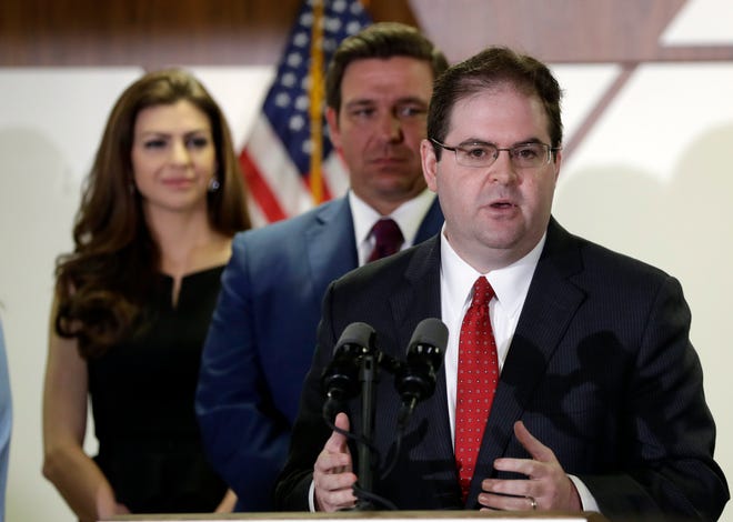 Former federal prosecutor and Miami appeals court judge Robert Luck, right, speaks after being appointed for a seat on the Florida Supreme Court by Republican Gov. Ron DeSantis, center, Monday, Jan. 14, 2019, in Miami. (AP Photo/Lynne Sladky)