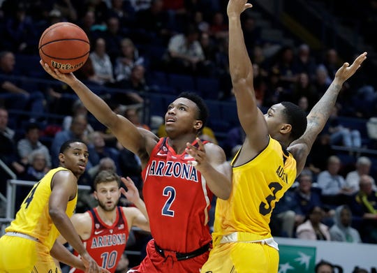 Arizona's Brandon Williams (2) lays up a shot past California's Paris Austin, right, in the second half of an NCAA college basketball game Saturday, Jan. 12, 2019, in Berkeley, Calif.