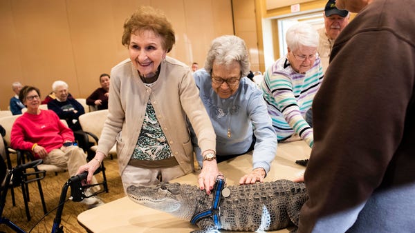 Gloria Watson, left, and Alice Brown pet Wally, a...