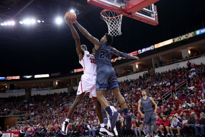 Fresno State's Nate Grimes (32) has his shot blocked by Nevada's Jordan Caroline during the Wolf Pack's win last month..