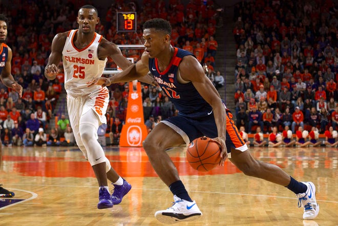Virginia Cavaliers guard De'Andre Hunter (12) drives to the basket while being defended by Clemson Tigers forward Aamir Simms (25) during the first half of the game at Littlejohn Coliseum.