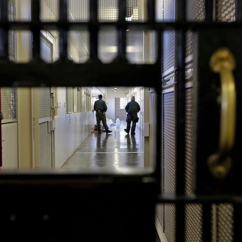 Guards walk a corridor at San Quentin State...