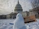 A snowman with a message about the government shutdown is pictured outside Capitol Hill