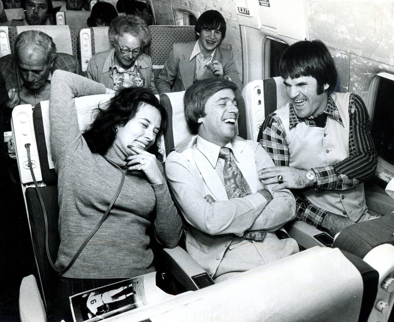 Marty Brennaman, center, Cincinnati Reds broadcaster sits with Pete Rose and Rose's first wife, Karolyn, on a flight from New York to Cincinnati after beating the NY Yankees in the 1976 World Series. Enquirer file photo by Mark Treitel, published Oct. 23, 1976.