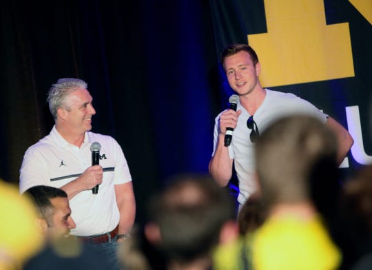 Matt Shepard talks with former U-M guard Spike Albrecht during a pep rally in San Antonio, March 30, 2018.