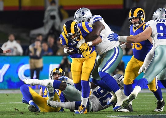 Dallas Cowboys defensive tackle Maliek Collins (96) tackles Los Angeles Rams running back Todd Gurley (30) in the first quarter in a NFC Divisional playoff football game at Los Angeles Memorial Coliseum.