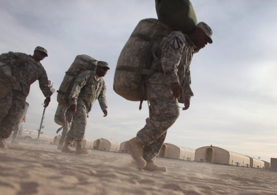 Army soldiers who had been in the Iraq War prepare to fly home to Fort Hood, Texas, from Kuwait in 2011.