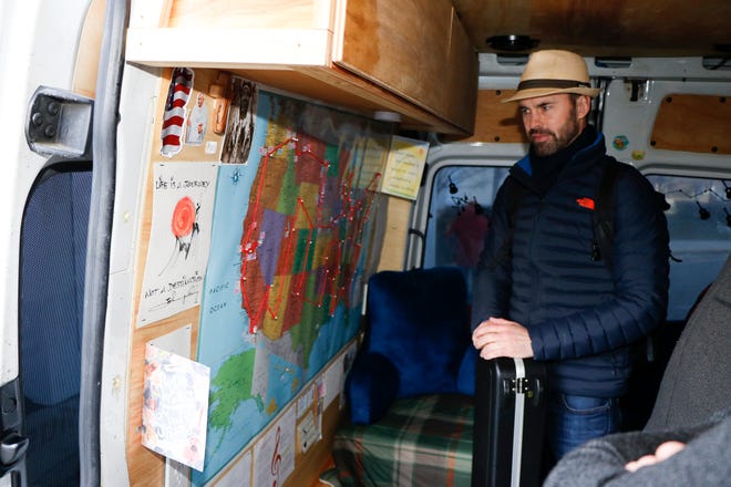 Ryan Brolliar shows his tour map inside the Jambulance