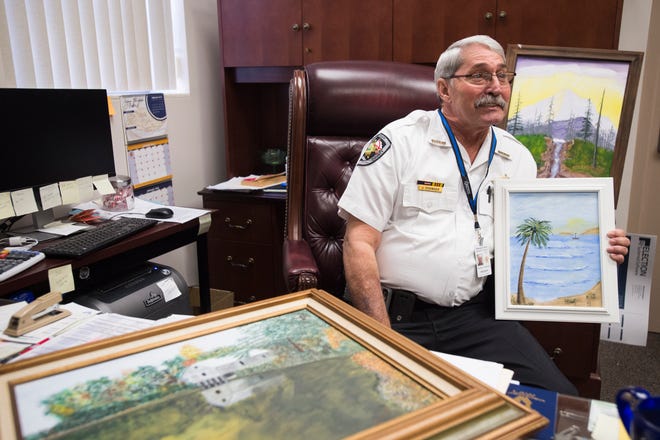 Autauga County Sheriff Joe Sedinger shows his paintings at his office in Prattville, Ala., on Wednesday, Jan. 16, 2019. 
