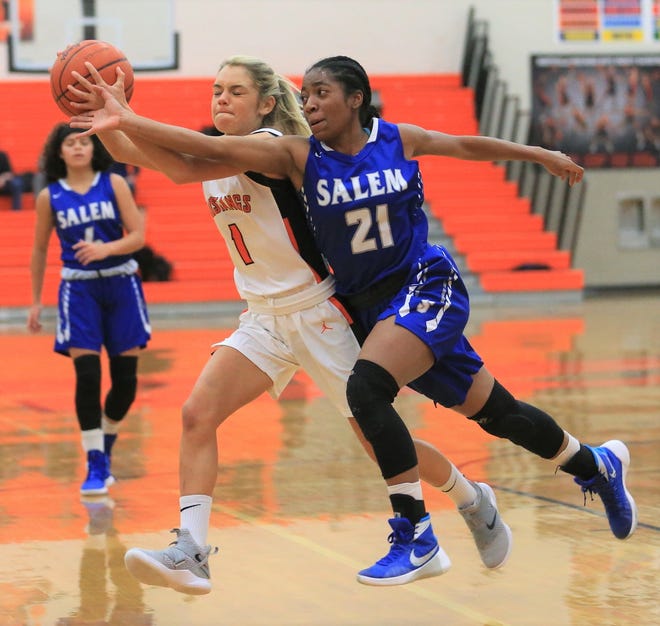 Salem's Mattison Joyner (21) and Northville's Jenna Lauderback contest for the loose ball in a KLAA West Division clash on Jan. 15.