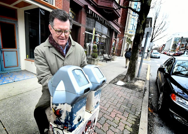Fred Callahan of Dover Township feeds a meter while parking on North Beaver Street Wednesday, Jan. 16, 2019. York City Council voted unanimously this week to lower the fineÂ for violating the street sweeping ordinance, but the costs for other parking tickets will increase in 2019.Â Bill Kalina photo