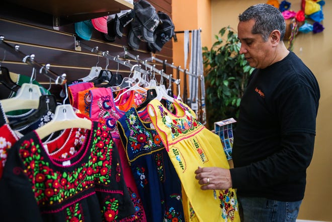 Hector Leos picks up a modern Mexican dress Wednesday, Jan. 16, 2019, at Leos Imports.