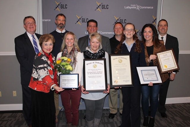 Alicia Kuckartz, front row second from the left, is presented with several awards along with the Small Business of the Year Award from the Greater Lafayette Commerce.