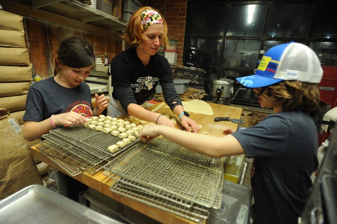 Rachel Wyman, owner of the Montclair Bread Company, enlists the help of her children, Josie and Keegan, to make donut nuggets for government employees at the Newark Airport.