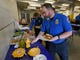 TSA employee Gary Vetterli prepares a hot dog during lunch at Salt Lake City International Airport, Jan. 16, 2019. The government shutdown has generated an outpouring of generosity to TSA agents and other federal employees who are working without pay. In Salt Lake City, airport officials treated workers from the TSA, FAA and Customs and Border Protection to a free barbecue lunch as a gesture to keep their spirits up during a difficult time.