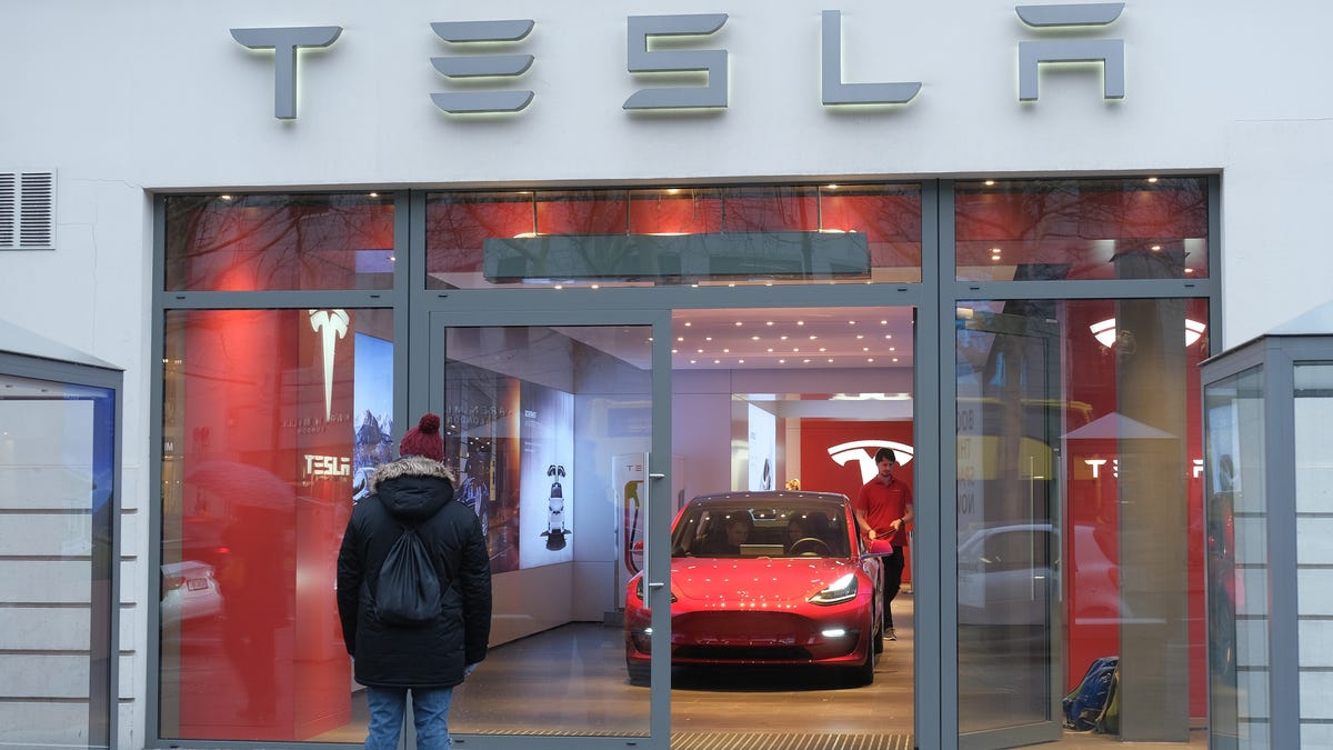 A man is pictured outside a Tesla dealership in Berlin, Germany.
