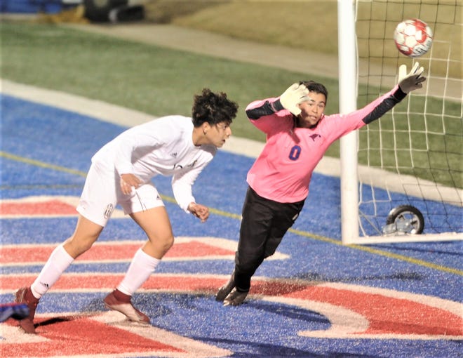 Abilene High's Jose Reyes, left, watches has his header sails past Cooper goalie David Damian for the game's first goal with 26:16 left in the first half. The teams played to a 2-2 tie in the nondistrict boys soccer game Friday, Jan. 18, 2019, at Shotwell Stadium.