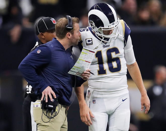 Los Angeles Rams head coach Sean McVay speaks with Jared Goff during the first half of the NFC championship game against the New Orleans Saints.