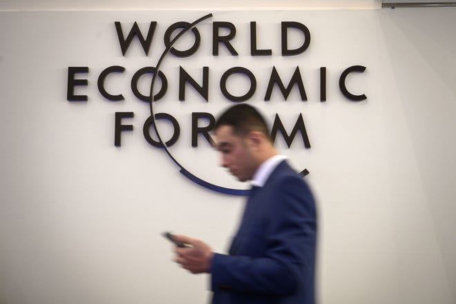 A man walks past a sign of the World Economic Forum (WEF) ahead of the WEF annual meeting at the Congress Centre on January 21, 2019 in Davos, eastern Switzerland.