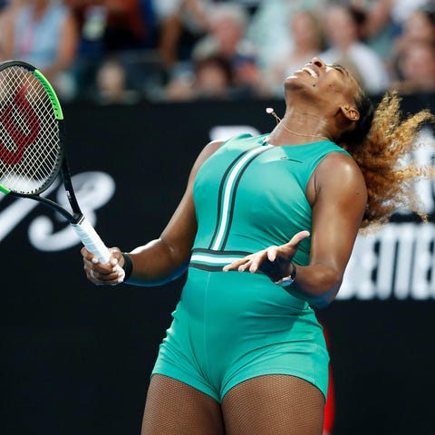Serena Williams reacts after a point against...