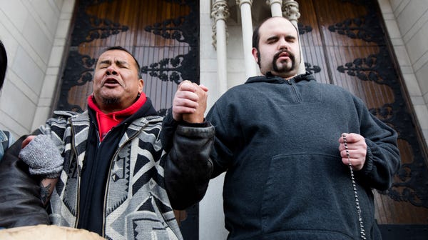 Nathan Hall prays the rosary outside Cathedral...