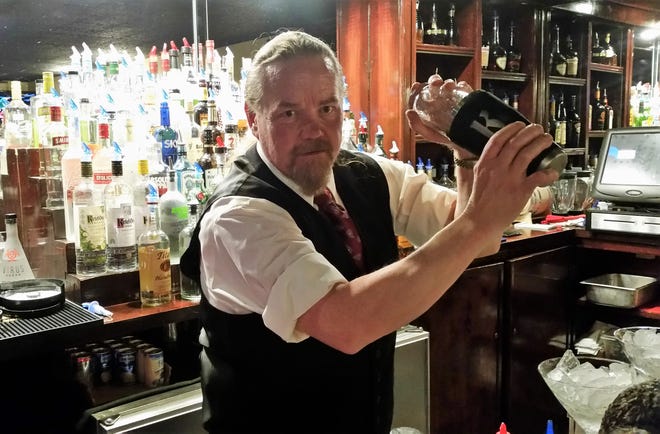 Ed Krause mixes a drink behind the bar at Ranchers in Ruidoso.